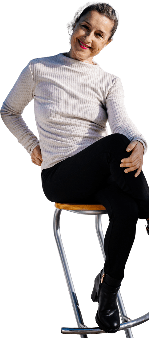Isabel, the teacher, sitting on a high stool and smiling
